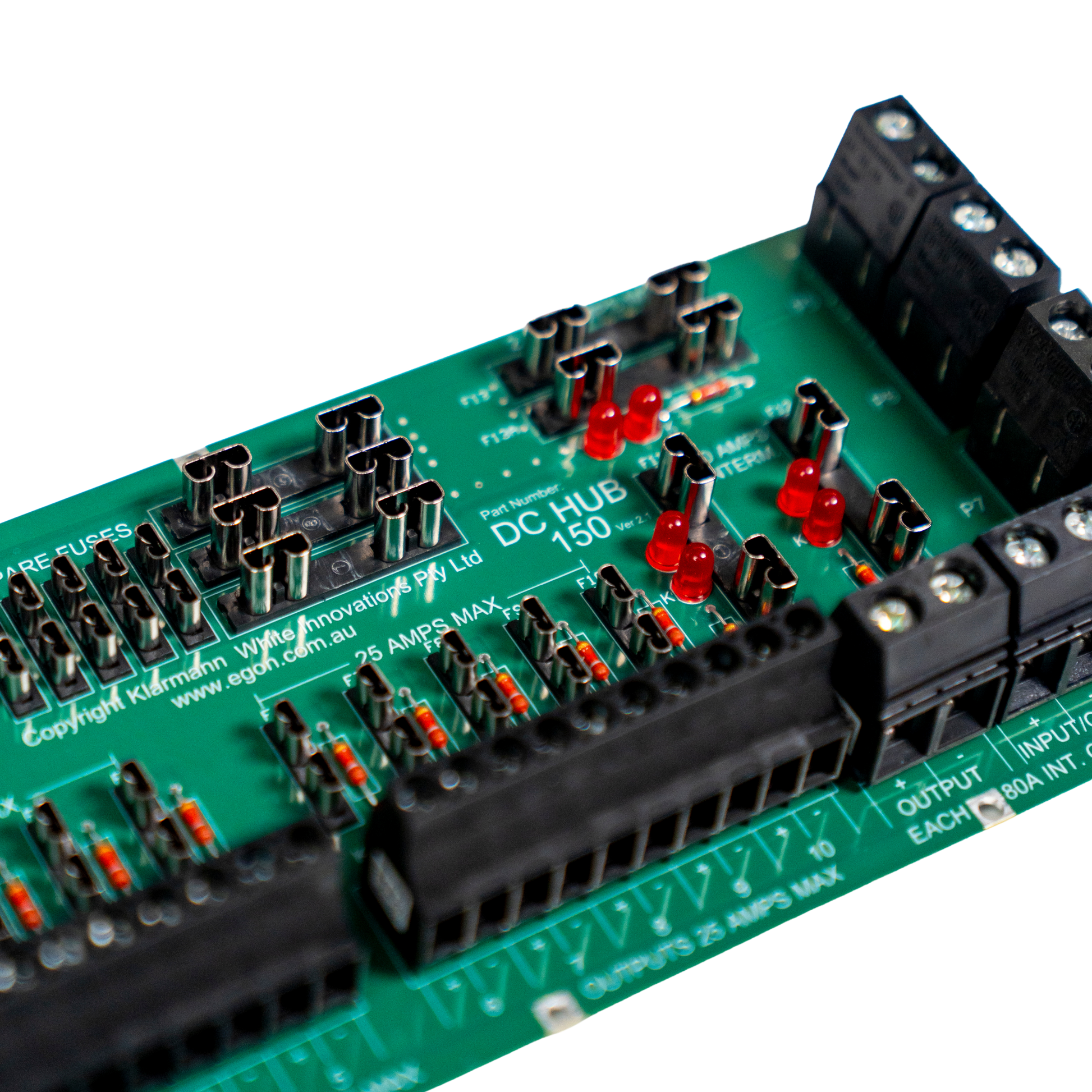 Close-up of a green electronic DC hub board with connectors and labels on a white background