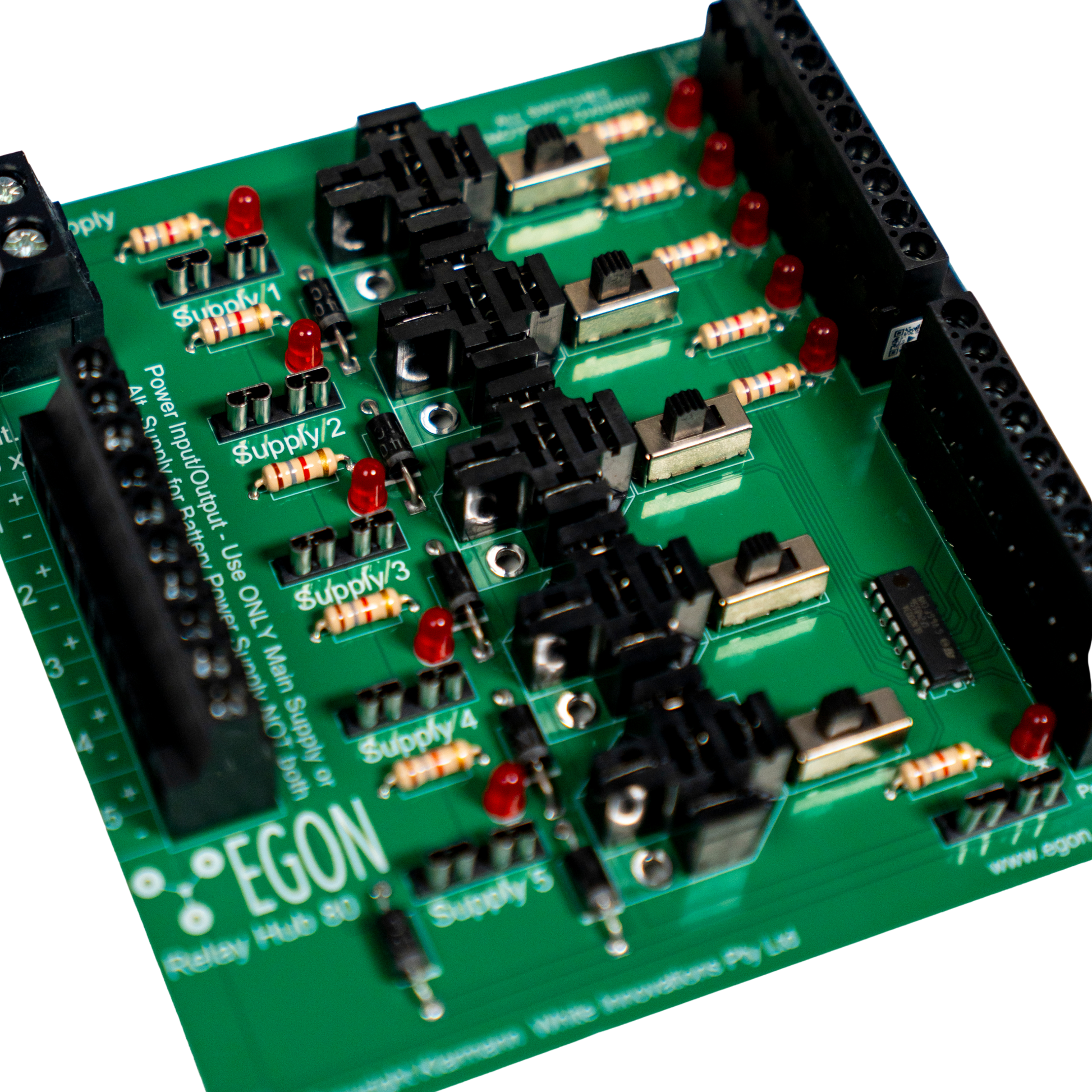 Close-up of a green electronic circuit board with components labeled 'EGON'.